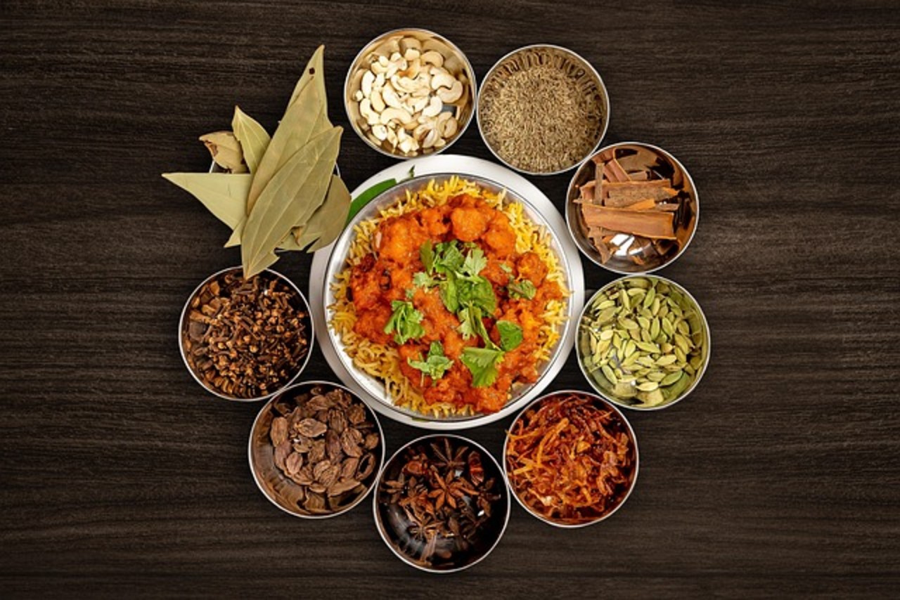 This picture shows little bowls of spices such as cardamom, cinnamon, and bay leaves; which are very popular in Bangladeshi cuisine